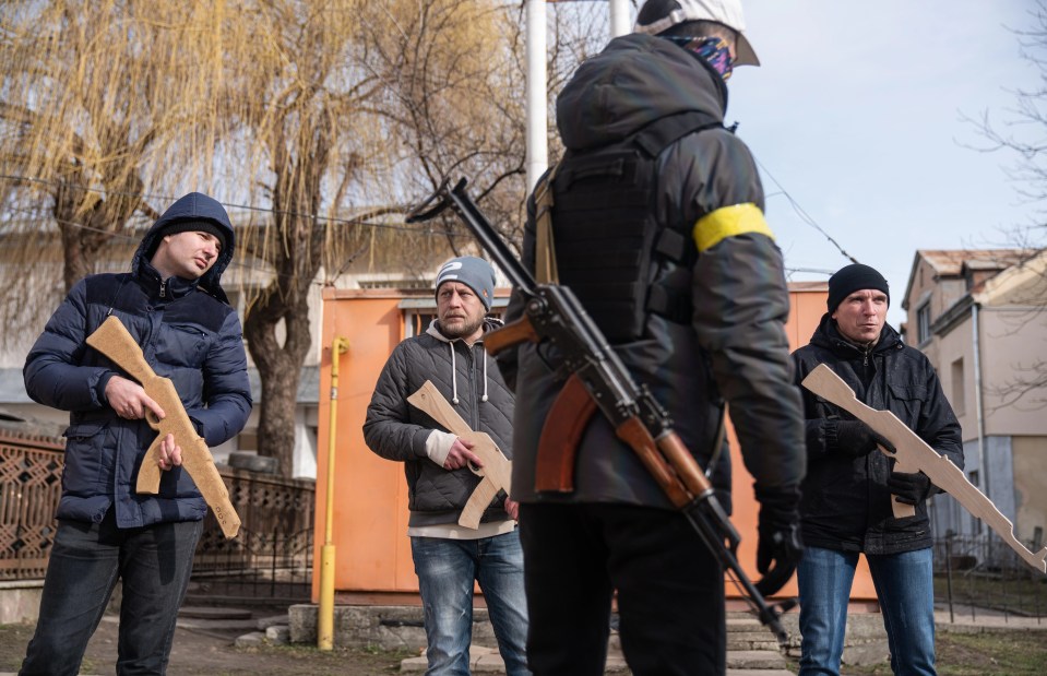 Ukrainians take part in military training ahead of the Russian assault