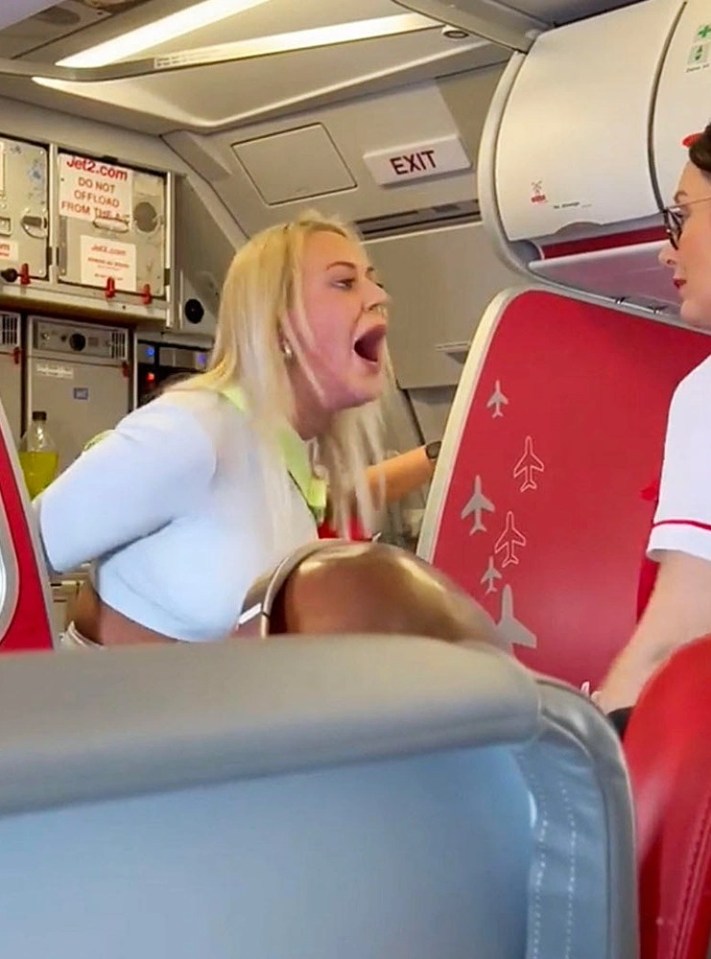 The irate woman was seen roaring in the face of a stewardess during her rampage