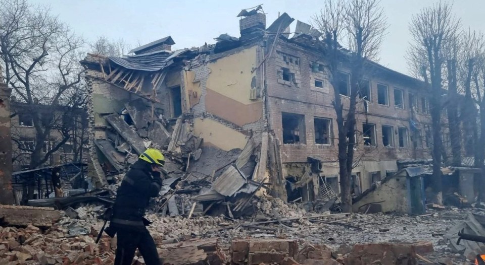 Firefighters are seen after airstrikes hit Dnipro