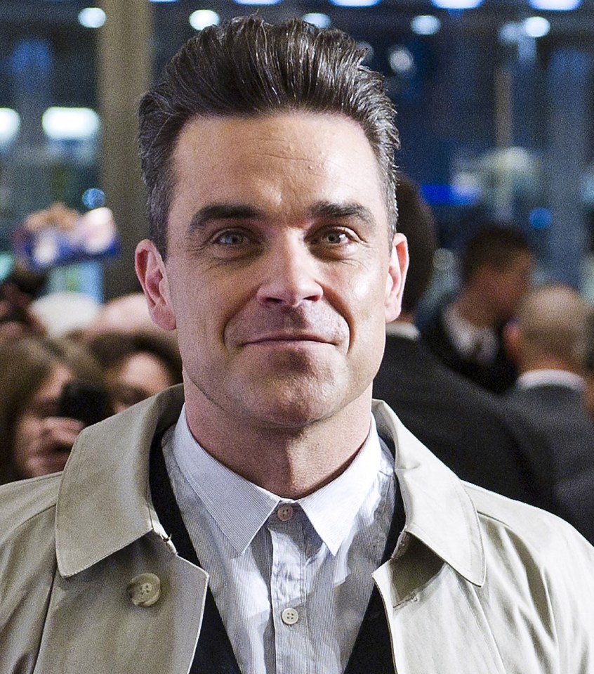 Robbie Williams misses his thick head of hair, above in 2013 after he had a successful hair transplant