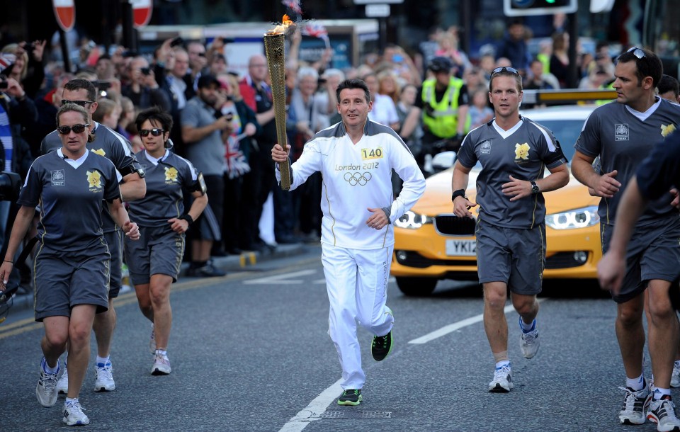 Lord Coe carries the Olympic torch ahead of the Games in 2012