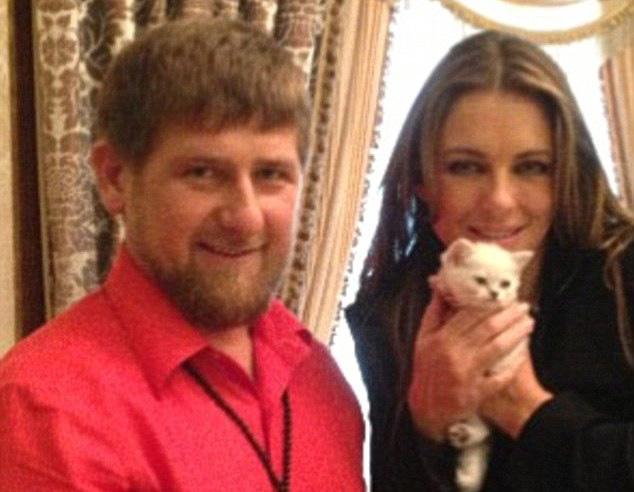 Ramzan Kadyrov poses with Liz Hurley as she holds a kitten