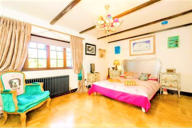 The master bedroom features a ceiling with lovely beams