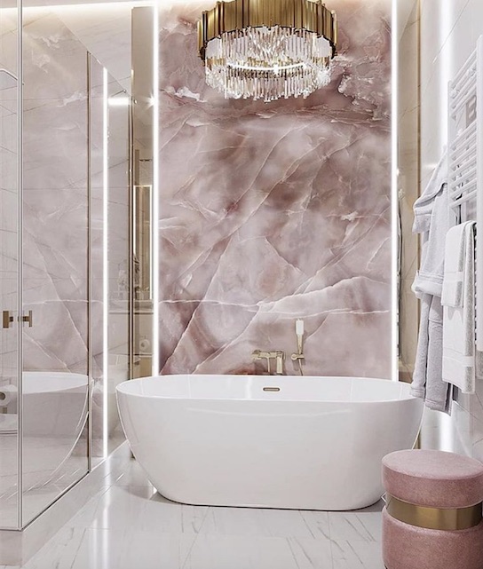 Jess has a huge free-standing bath under a large chandelier