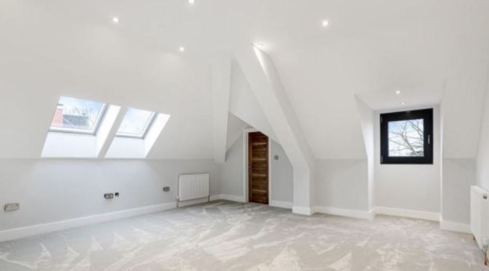 Sam's previous rented home has huge rooms with white walls and grey carpets