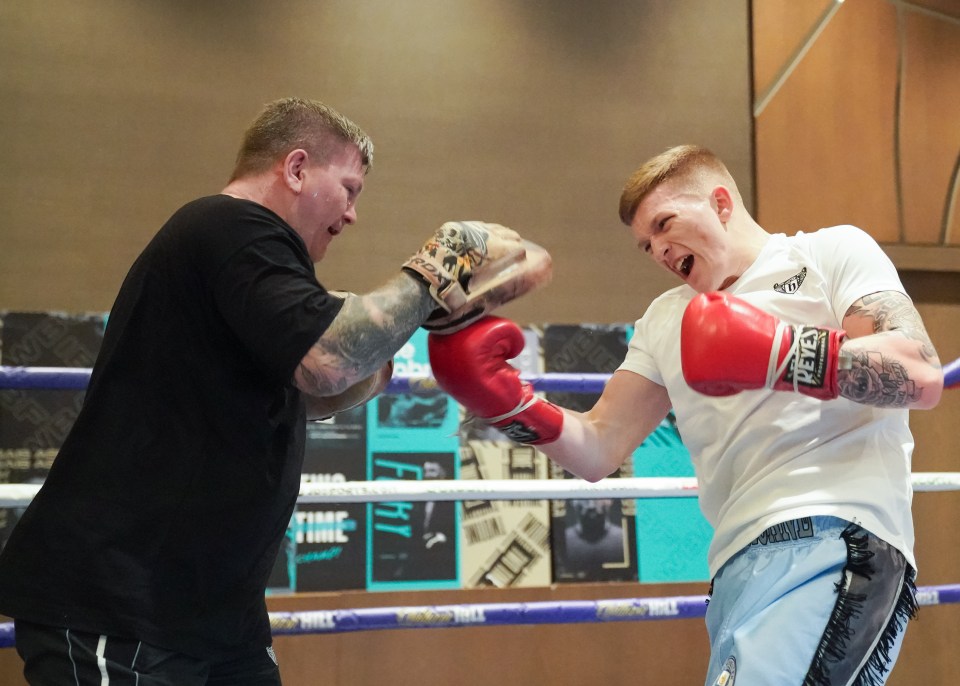 Ricky Hatton holding pads for son Campbell