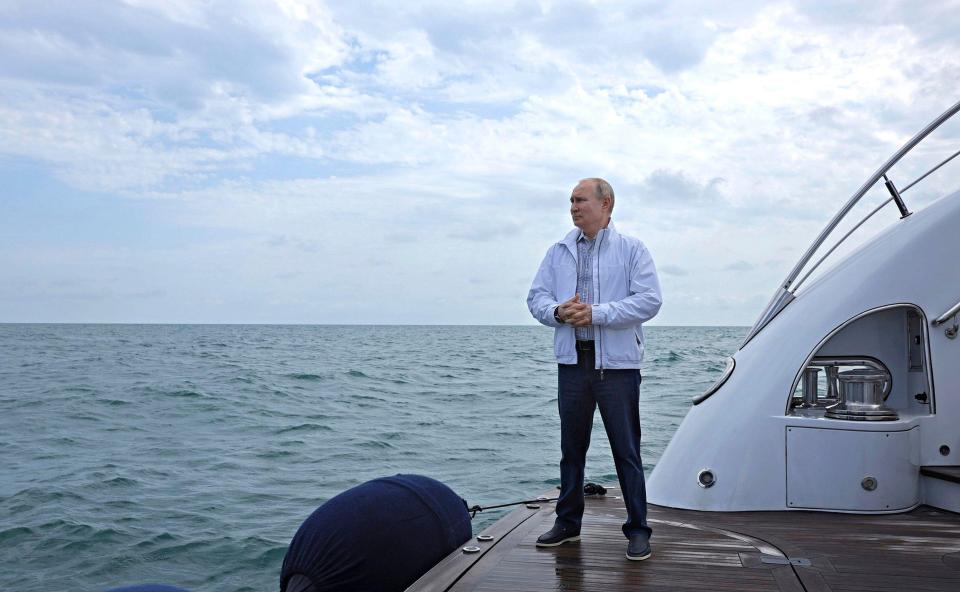 It is rumoured to belong to Putin, pictured here on a different yacht in Sochi