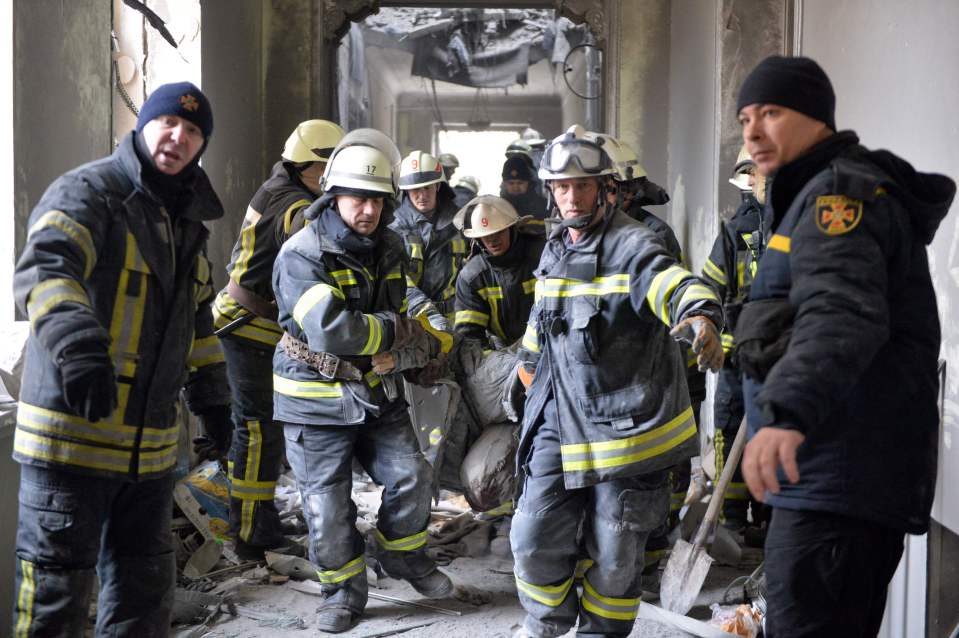 Firefighters remove a body from a building in the devastated Kharkiv