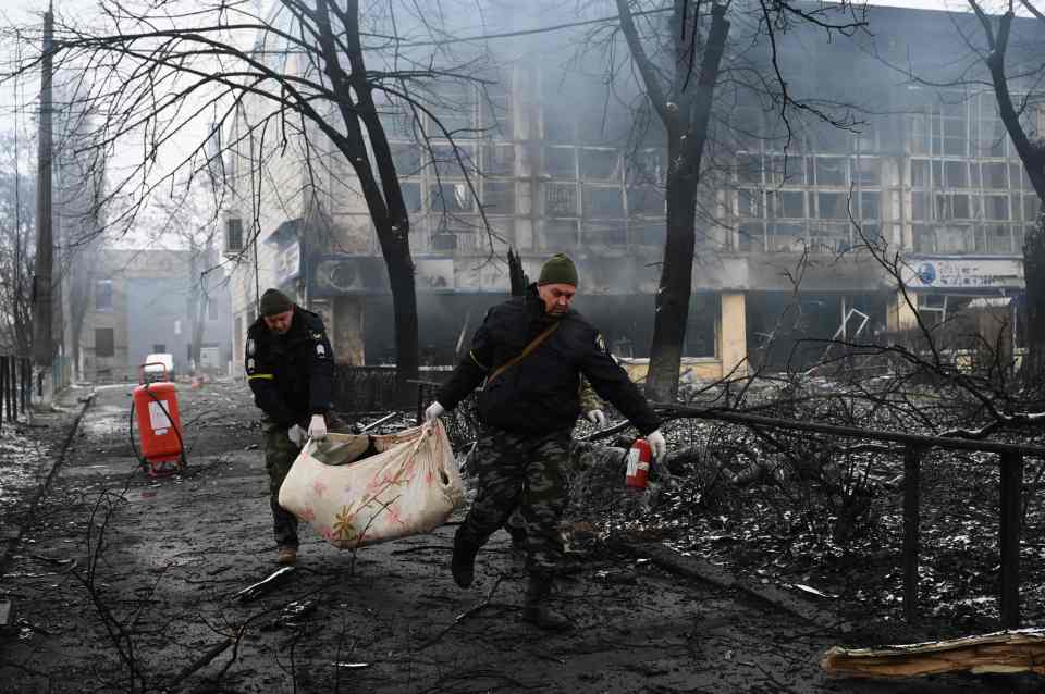 Ukrainians clear bodies from the streets after a strike on Kyiv