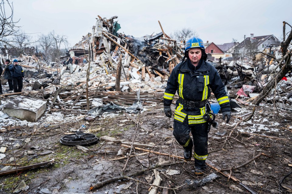 Firefighters pick through the rubble in a residential district of Zhytomyr