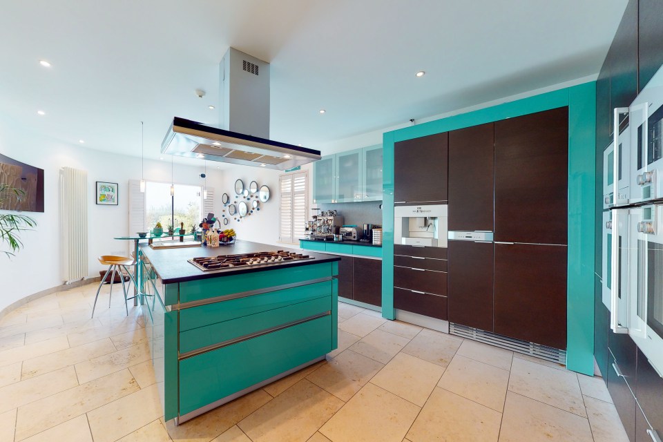 The contemporary kitchen has plenty of workspace and storage