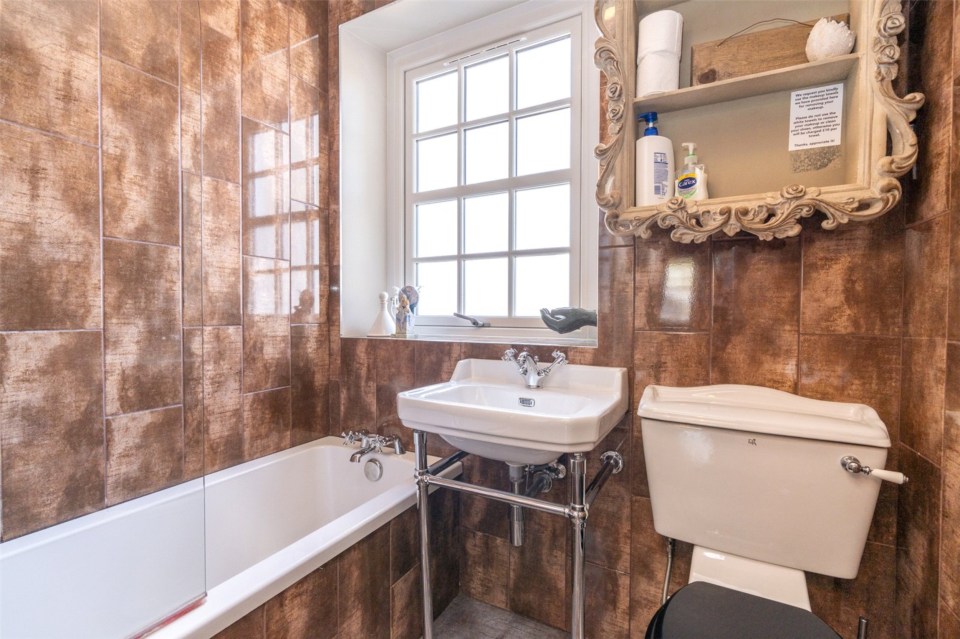 Even the bathroom features an ornate cabinet like something out of the books