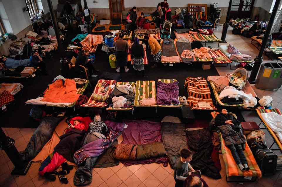 Refugees from Ukraine rest at a temporary shelter in the main train station of Krakow, Poland