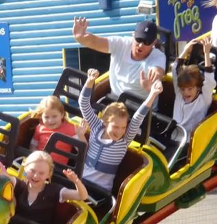 Shane seen riding a rollercoaster with his adoring family