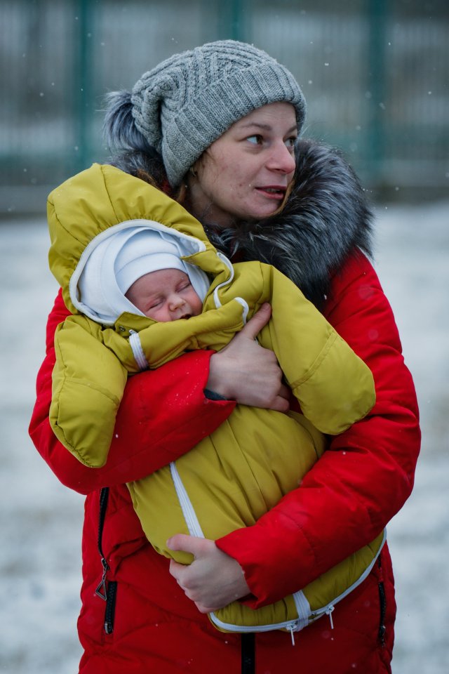 Ukrainian refugees cross the border during snowfall to Medyka, Poland