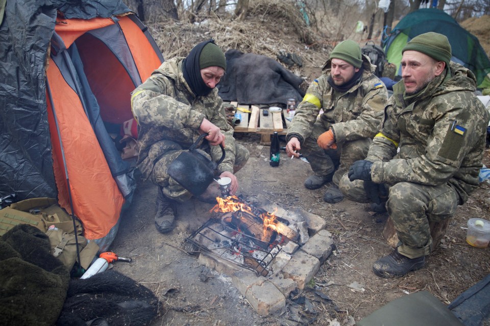 Members of the Ukrainian military sit near Kyiv