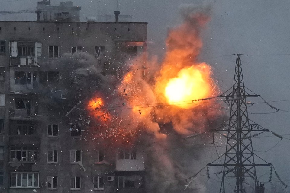 An explosion in a building that came under fire from a Russian army tank in Mariupol