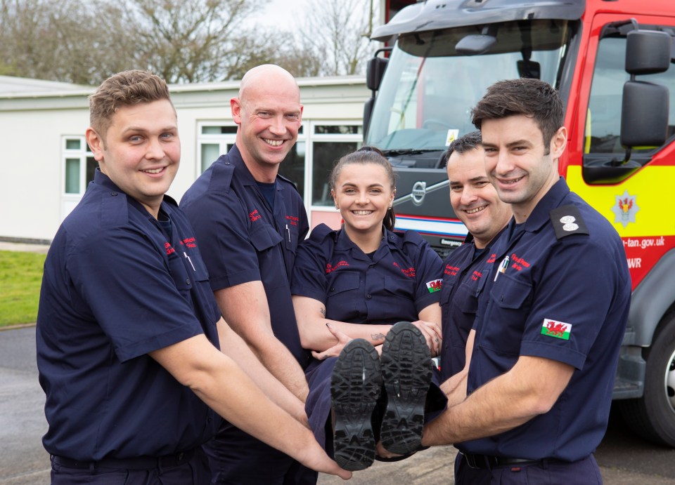 Charlotte's colleagues carry her and strike a pose for this funny snap