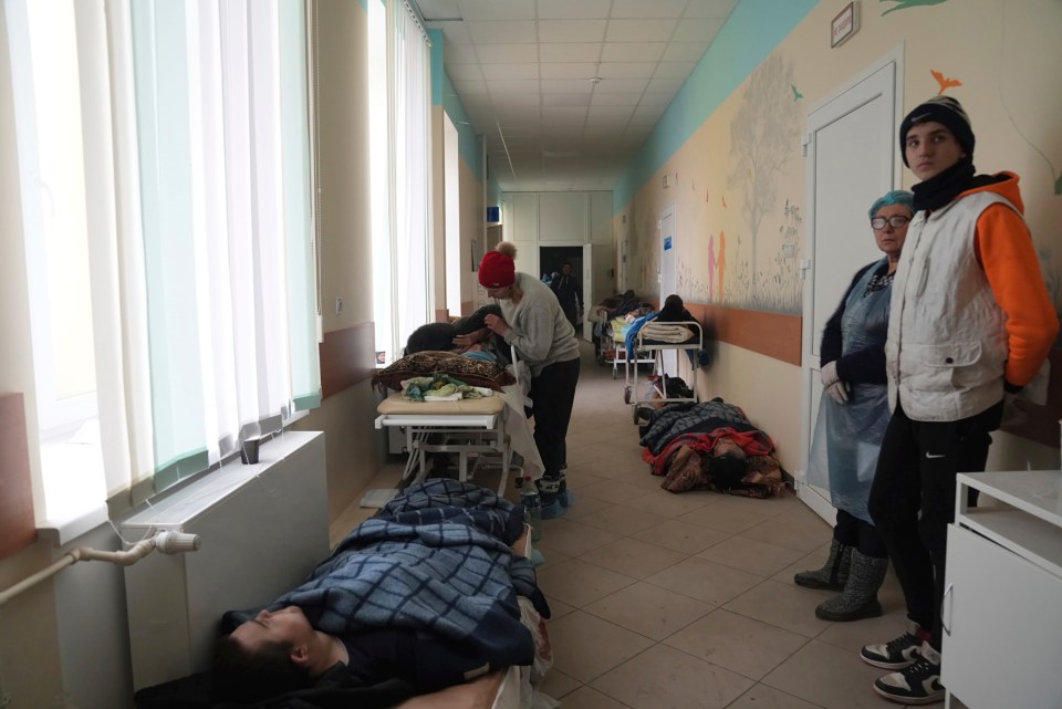 People injured by shelling lay in the hall of hospital three in the city