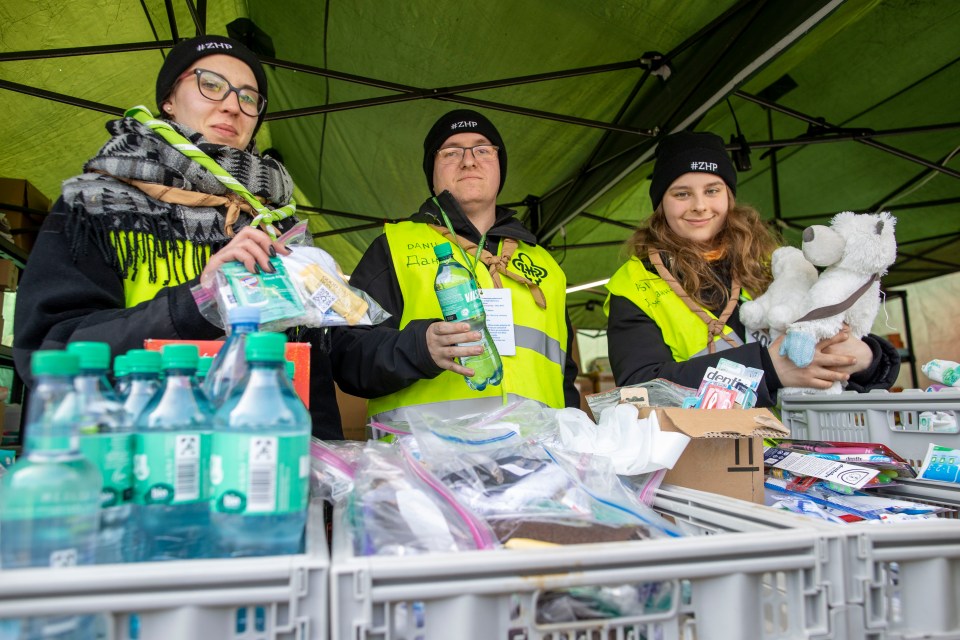 Polish volunteers wait at the Medyka border crossing to offer fleeing Ukrainians some basic necessities