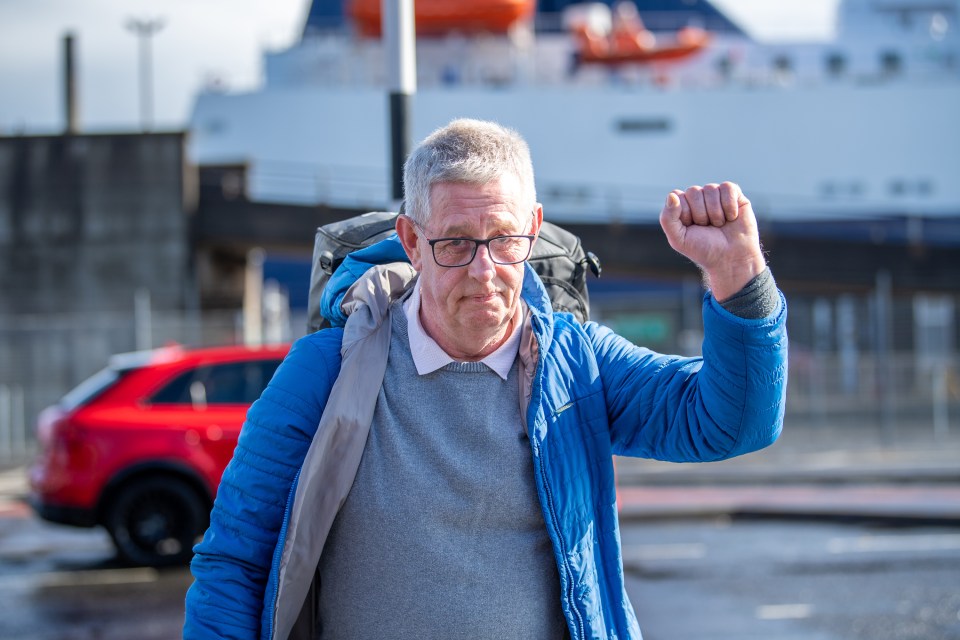 A defiant crew member raises his fist after the mass axing