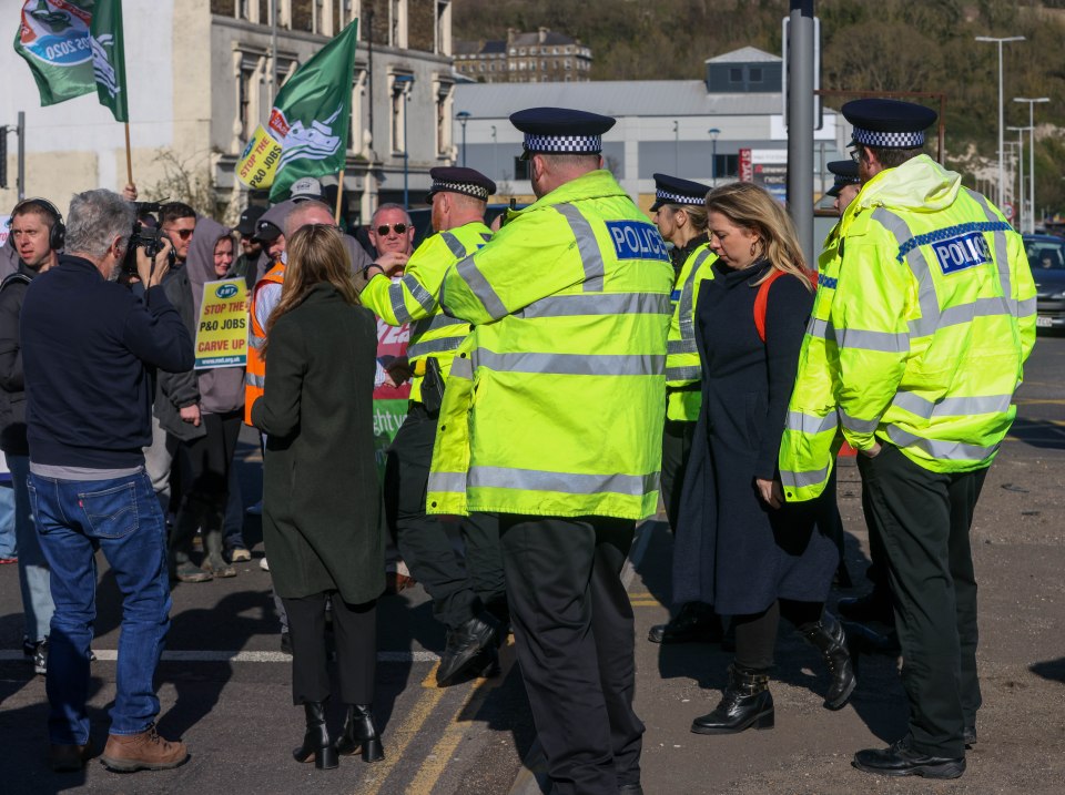 Police watch the protesters on the road leading to the Port of Dover