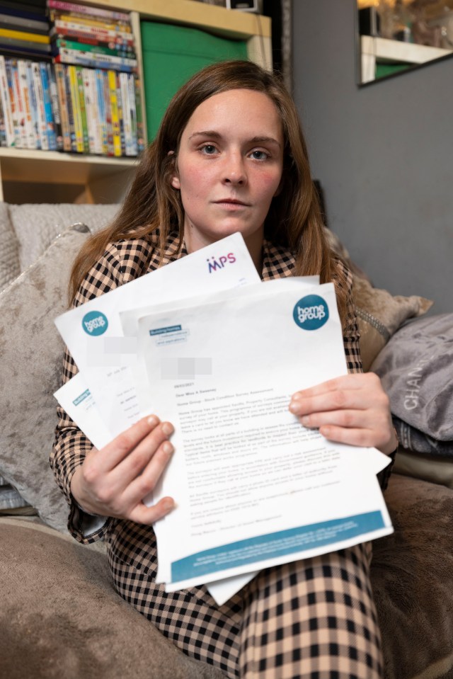 Alisha with many letters she has received from her housing provider ignoring her issues