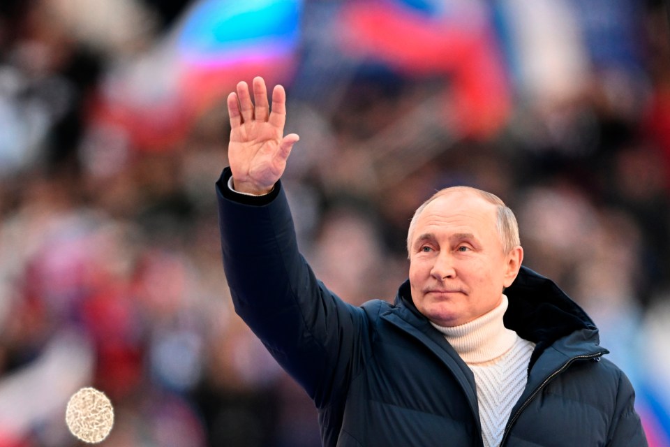 Vladimir Putin greets people at the 80,000-capacity Luzhniki stadium