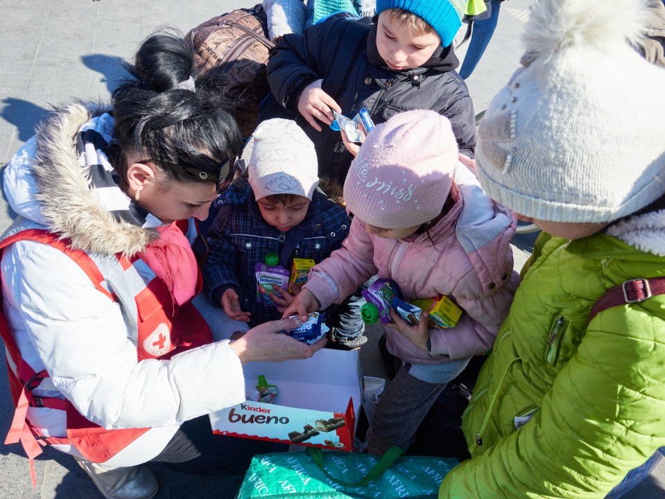 Volunteer Mariana hands out treats for Artem and the other children