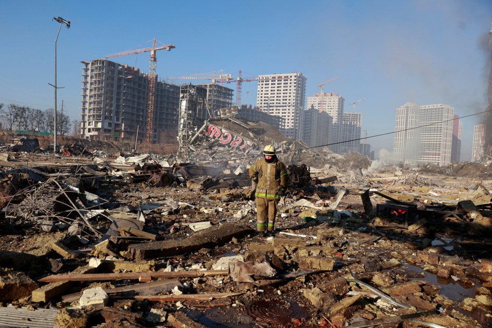 A rescue worker stands at the site of a military strike in Kyiv