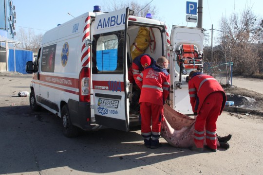 The body of a man being taken into an ambulance