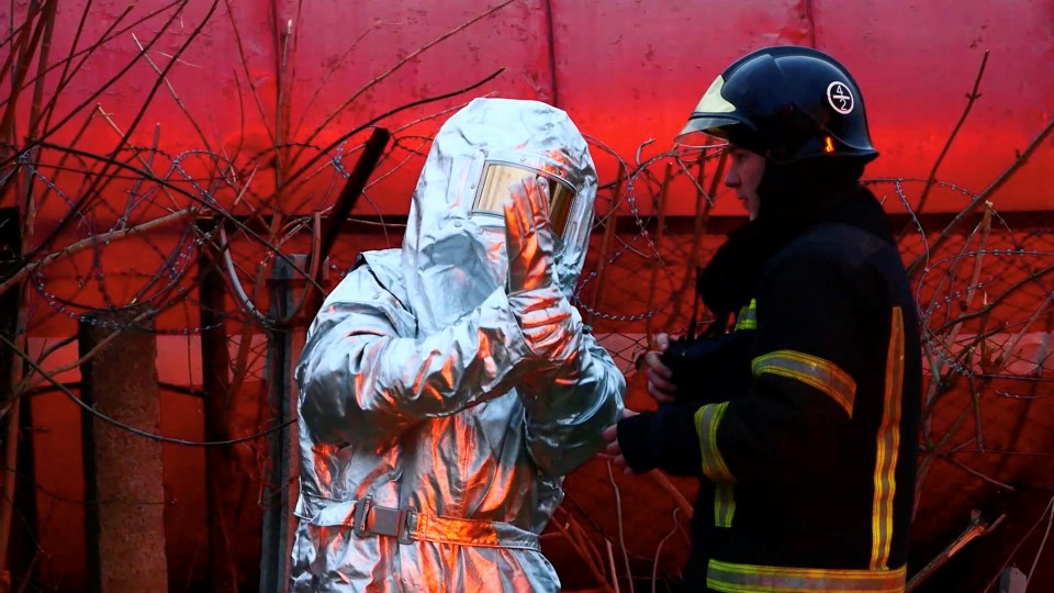 First responders work at a site of fuel storage facilities hit by cruise missiles, as Russia's attack on Ukraine continues