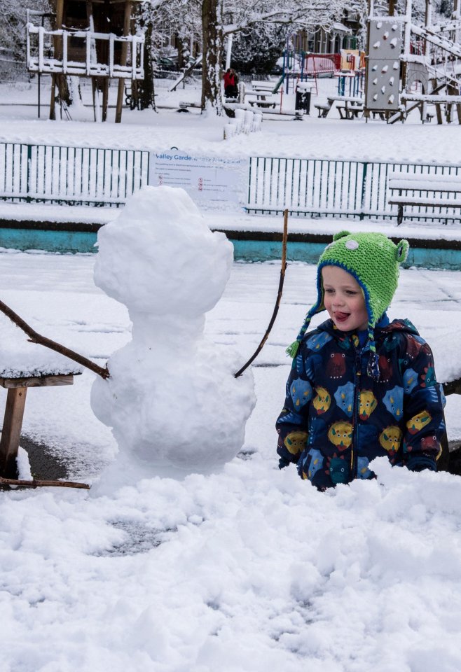 Gaby, 4, with the snowman she has just made with her mum in the Valley Gardens