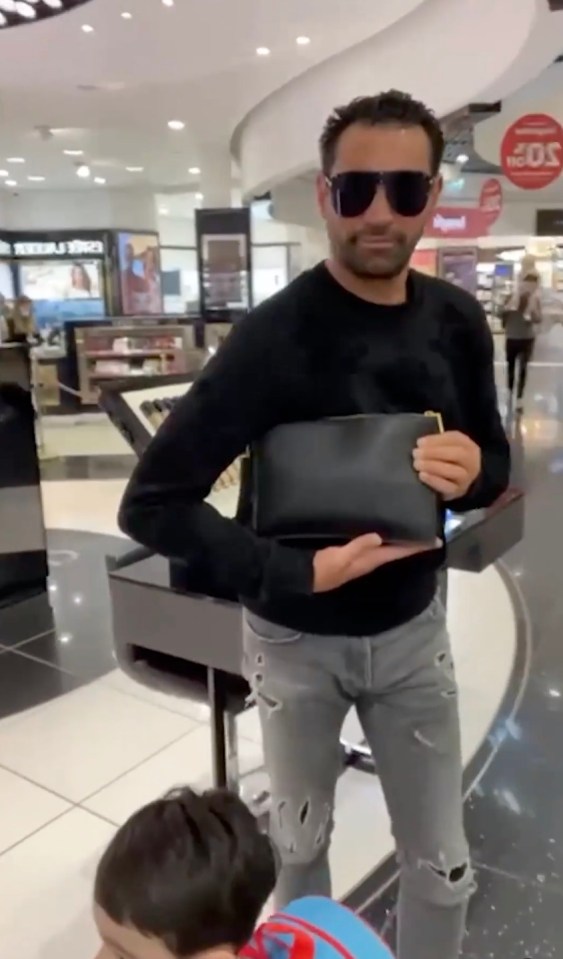 The star filmed her fiance showing off his man bag at the airport