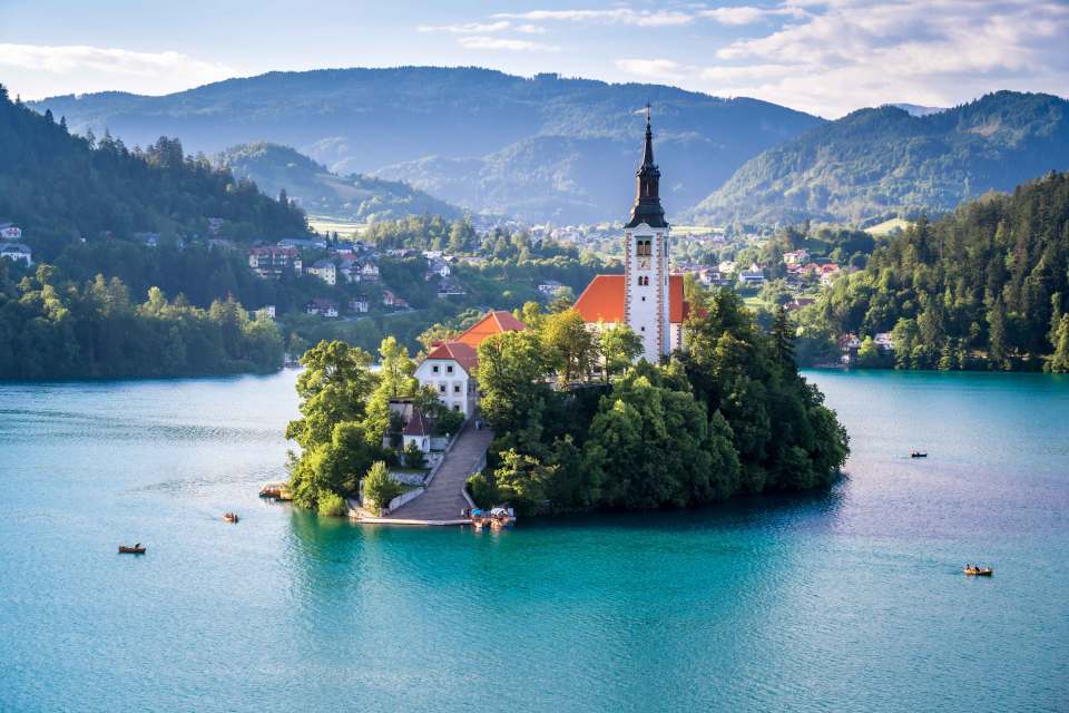 Slovenia’s most iconic attraction is the beautiful vast Lake Bled which is surrounded by imposing mountains