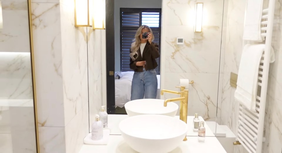 The en suite is adorned with gold and marble