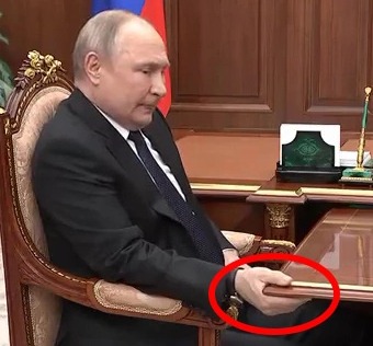 A sickly Putin appeared in pain as he was seen tightly gripping a table