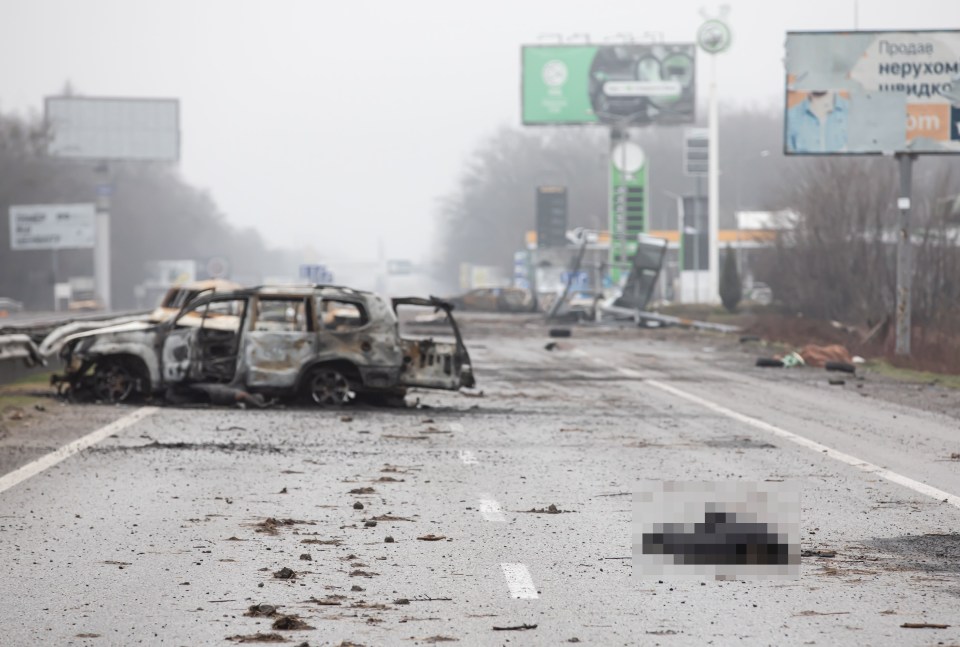 A civilian's body can be seen lying on a highway 12 miles from Kyiv