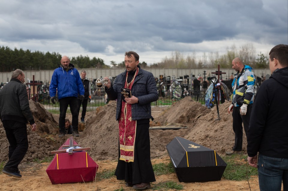 Services were conducted by local priest Andriy Holovin as devastated families said their last goodbyes