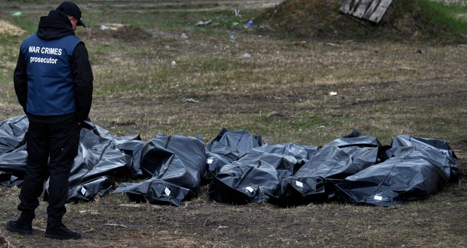 Ukraine began the grim task of digging up a mass grave yesterday where at least 400 victims of Russian atrocities are thought to be buried.