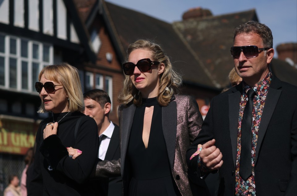 Kelsey (centre) leads Tom Parker's cortege at his funeral today