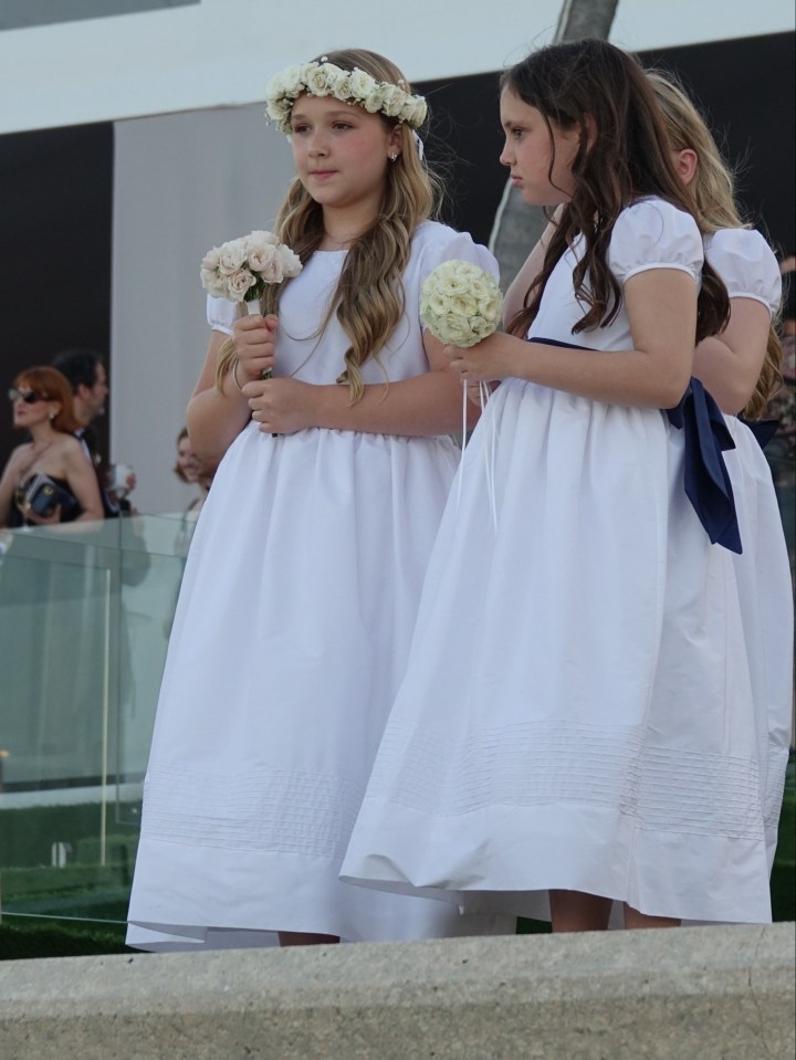 Brooklyn's younger sister Harper, left, was among the bridesmaids at the wedding in Miami