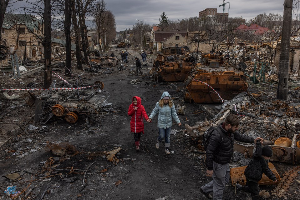 Residents of Bucha walk through their destroyed town, a centre of Russian atrocities against civilians