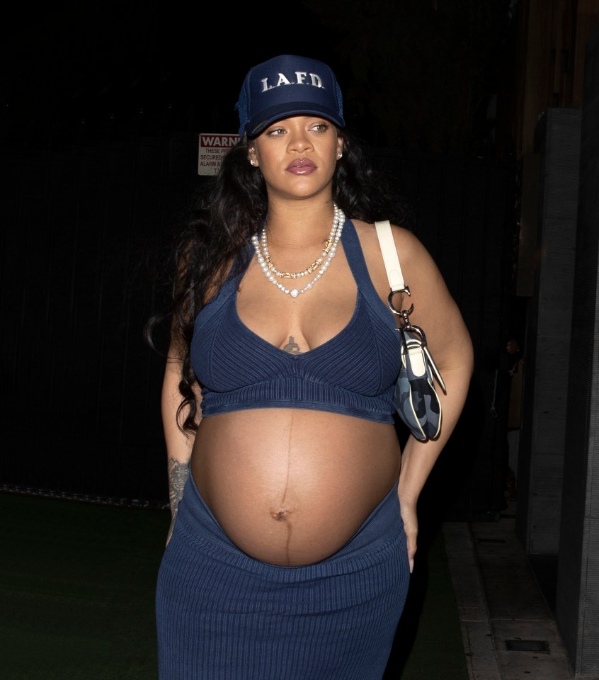 Superstar singer Rihanna caps off her glamorous pregnancy look with a blue baseball hat