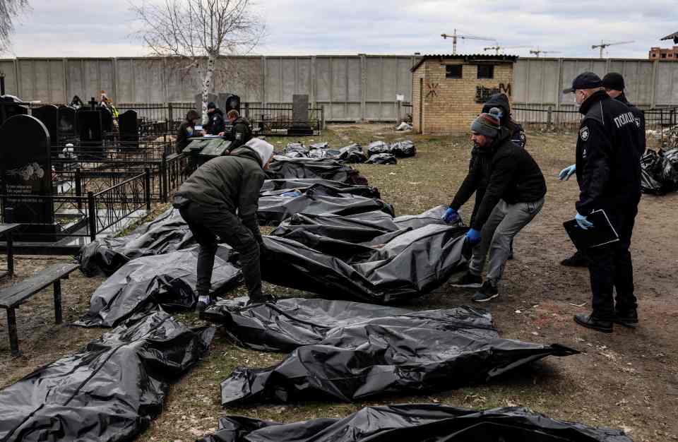 Bodies found in areas that Russian troops withdrew from were laid out in the town's cemetery