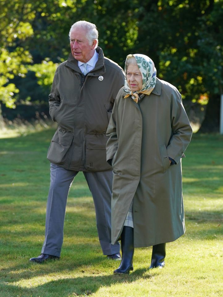 Prince Charles and the Queen walk at Balmoral in 2021