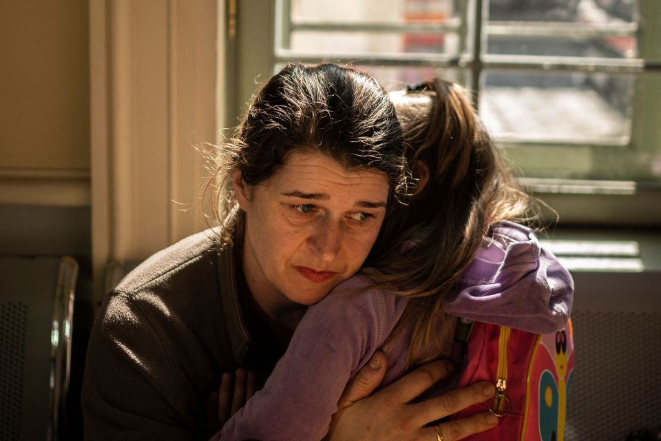 A Ukrainian mother hugs her child at a train station near to the Poland border