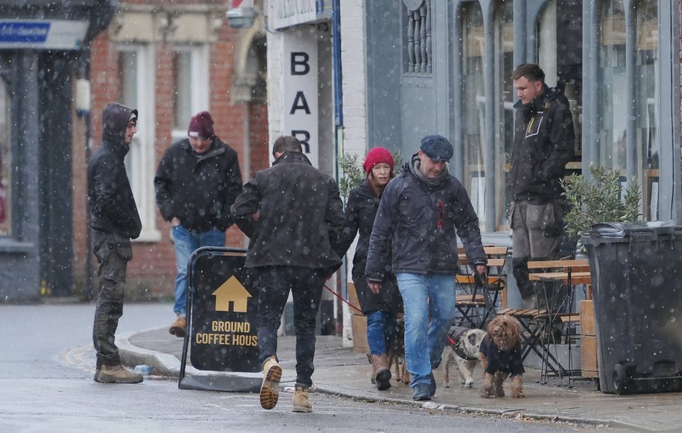 Shoppers walk through light snow in Burnham-on-Crouch, Essex