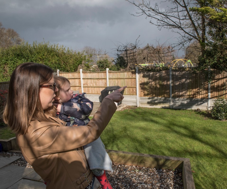 Leah and her daughter looking out onto the playground where gangs of yobs gather