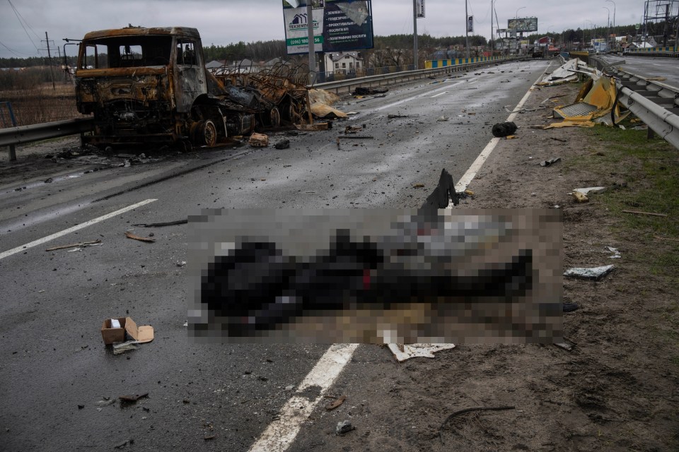 The lifeless body of a Russian soldier lies on the ground in Bucha, in the outskirts of Kyiv, on Saturday